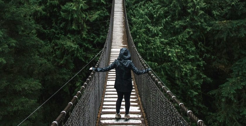 person walking across bridge