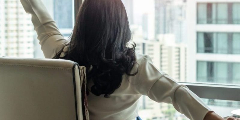 woman stretching with a cup of tea