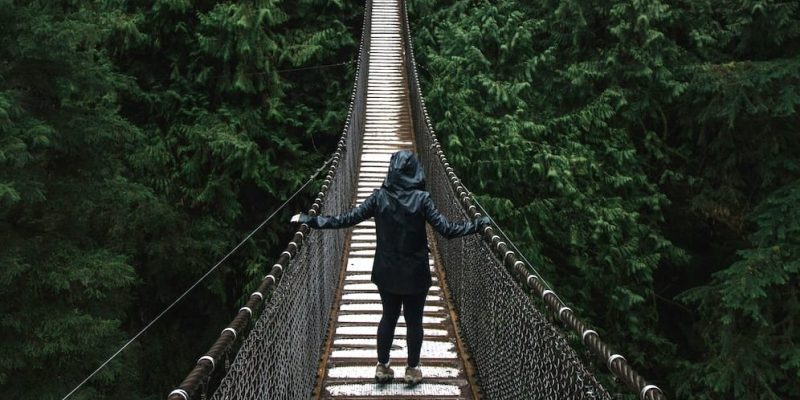 person walking across bridge