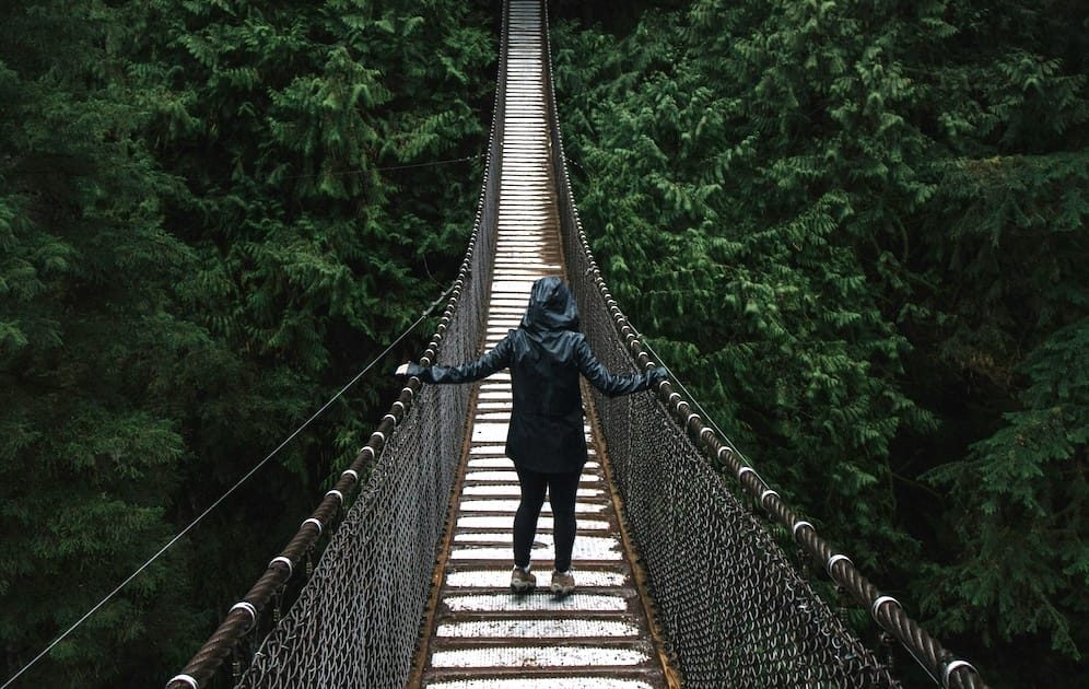 person walking across bridge