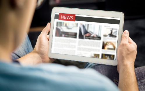person looking at news on ipad