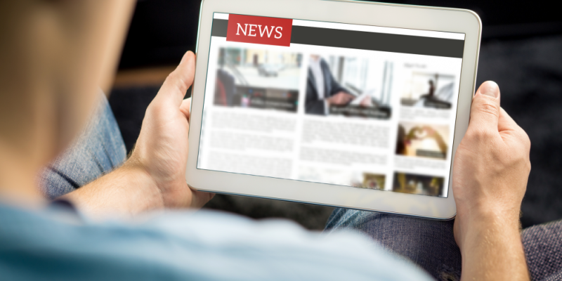 person looking at news on ipad