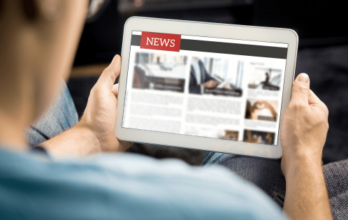 person looking at news on ipad