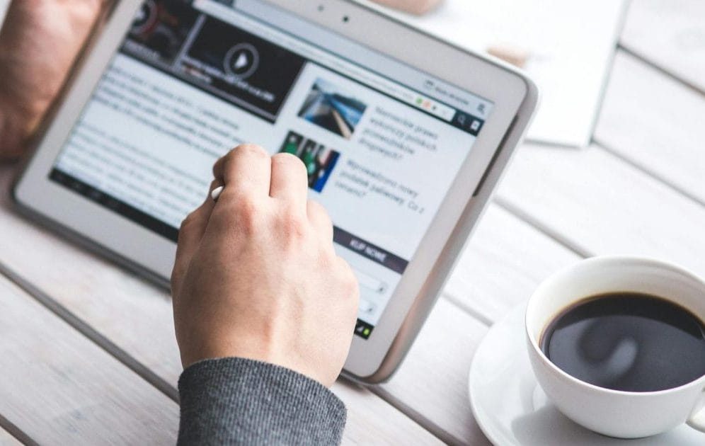 person reading news on tablet